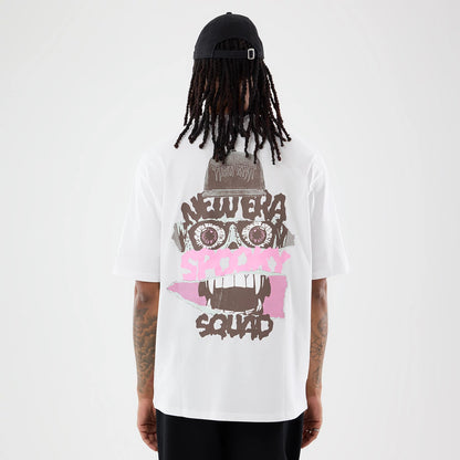 The model is wearing this New Era Spooky Graphic Oversized T-Shirt in white. 2