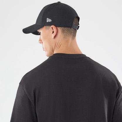 The model is wearing this New Era Skull Graphic Oversized T-Shirt in black. 7