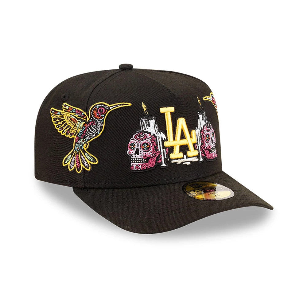 LA Dodgers MLB Day Of The Dead Black New Era 59FIFTY A-Frame Fitted Cap, three-quarter view showing multicoloured embroidered skulls and hummingbird on front panels, with prominent gold LA logo in the centre.