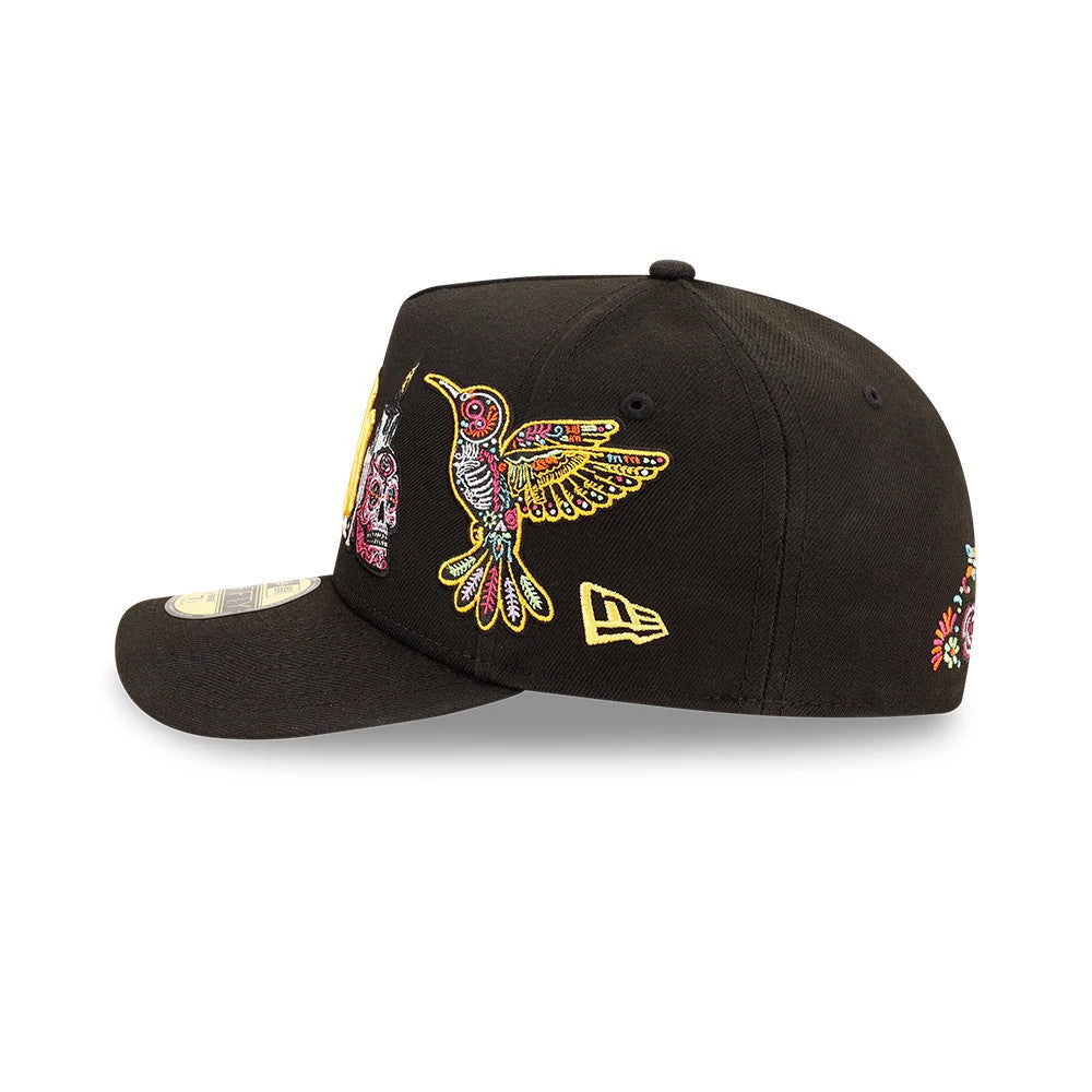 Yankees MLB Day Of The Dead Black New Era 59FIFTY A-Frame Fitted Cap, side view showing a detailed embroidered hummingbird and skull graphic in colours on the black crown, with the New Era flag logo on the left side.