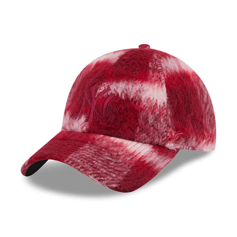 New Era New York Yankees MLB Fabric Story Red Casual Classic Adjustable Cap, three-quarter view showing the embroidered NY logo on the red and white textured fabric crown, with a curved visor and the New Era flag logo on the left side.