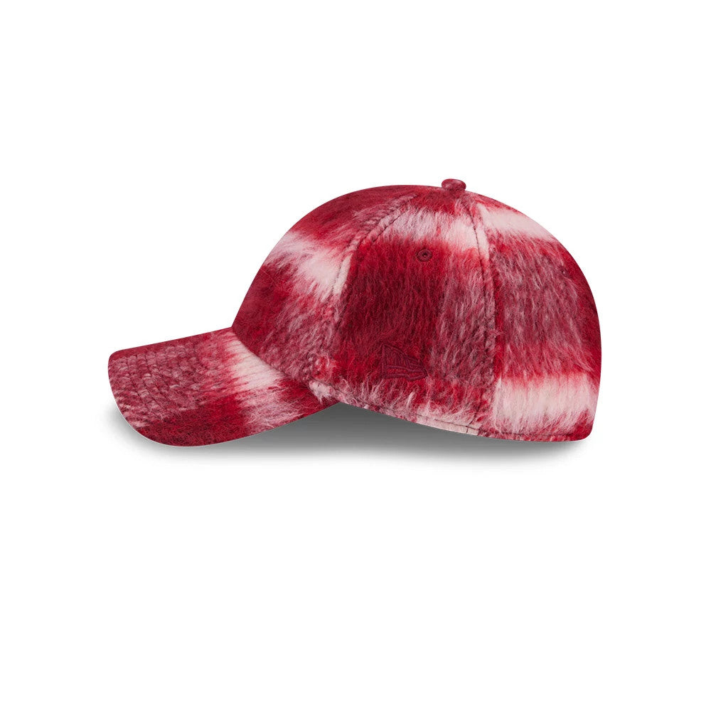 New Era New York Yankees MLB Fabric Story Red Casual Classic Adjustable Cap, side view showing a plush textured surface with a red and white pattern, the New Era flag logo embroidered on the left side, and a curved visor.