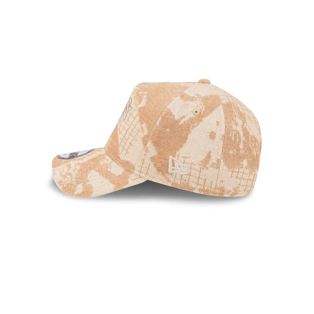 New York Knicks NBA Fall Story Beige New Era 9FORTY A-Frame Adjustable Cap, side view showing the beige camo pattern across the structured crown, New Era flag logo on the left side, and a grey size sticker on the curved visor.