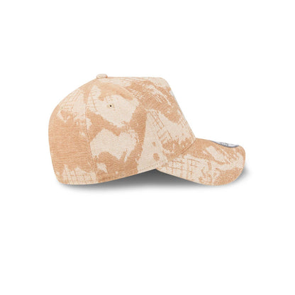 LA Dodgers MLB Fall Story Beige New Era 9FORTY A-Frame Adjustable Cap, side view showing a uniquely patterned beige fabric across the crown and curved visor, with a single eyelet on each panel and the New Era flag logo embroidered on the left side.