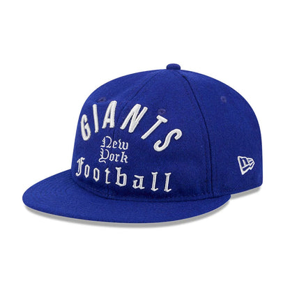 Giants NFL Historic Arch Dark Blue Retro Crown New Era 59FIFTY Fitted Cap, three-quarter view showing raised white embroidered Giants lettering on the front panel, a blue flat visor, and the New Era flag logo on the left side.