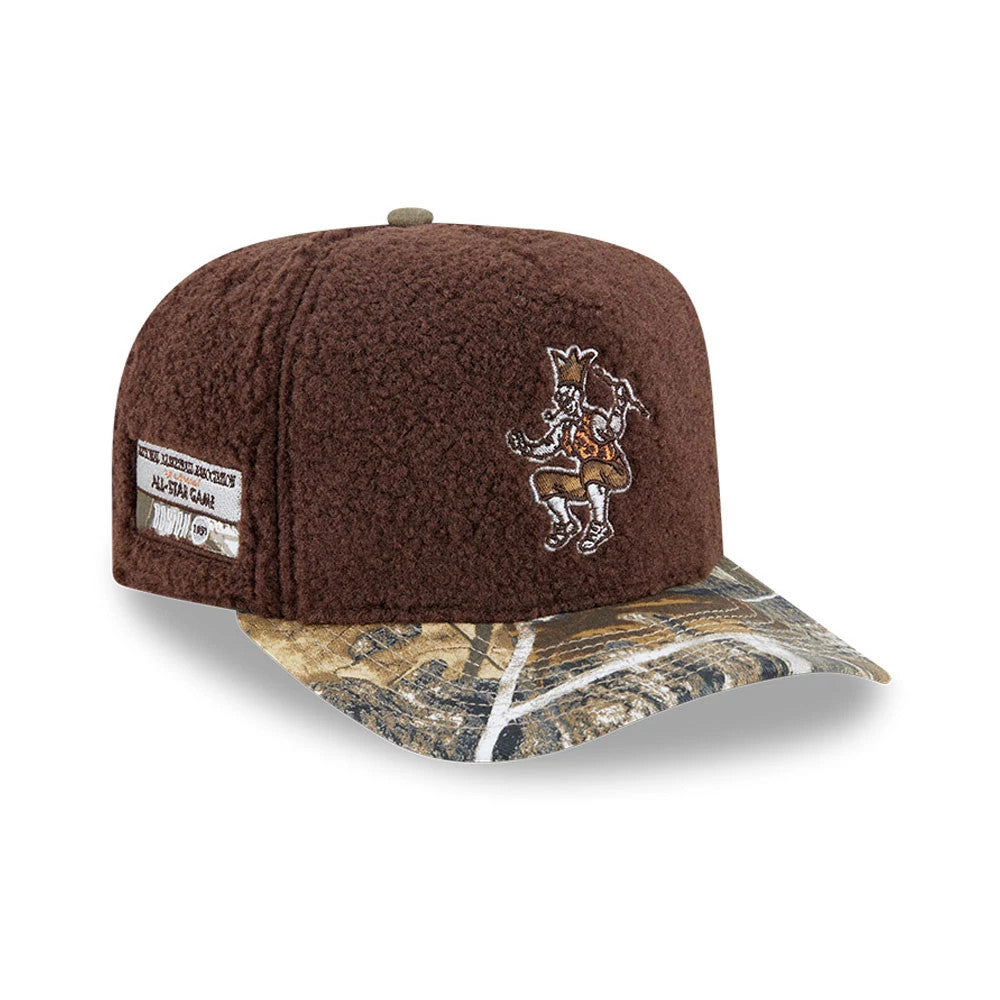 Boston Celtics NBA Hardwood Classic Brown New Era 59FIFTY A-Frame Fitted Cap, three-quarter view showing the embroidered Celtics logo on the front panel, a multi-coloured camouflage visor, and a textured fabric design with a patch on the side.