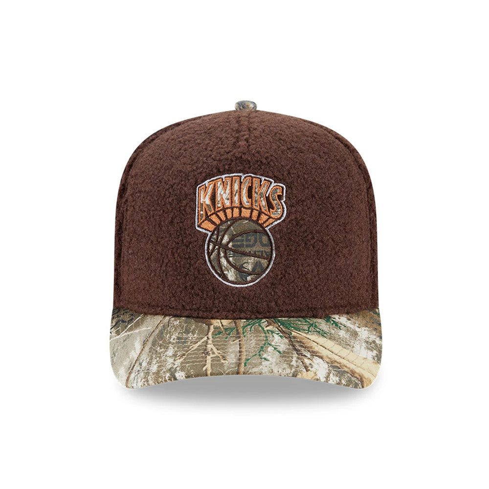 New York Knicks NBA Hardwood Classic Brown New Era 59FIFTY A-Frame Fitted Cap, front view showing the orange and brown embroidered Knicks logo on the structured brown crown, with a camouflage-patterned flat visor below.