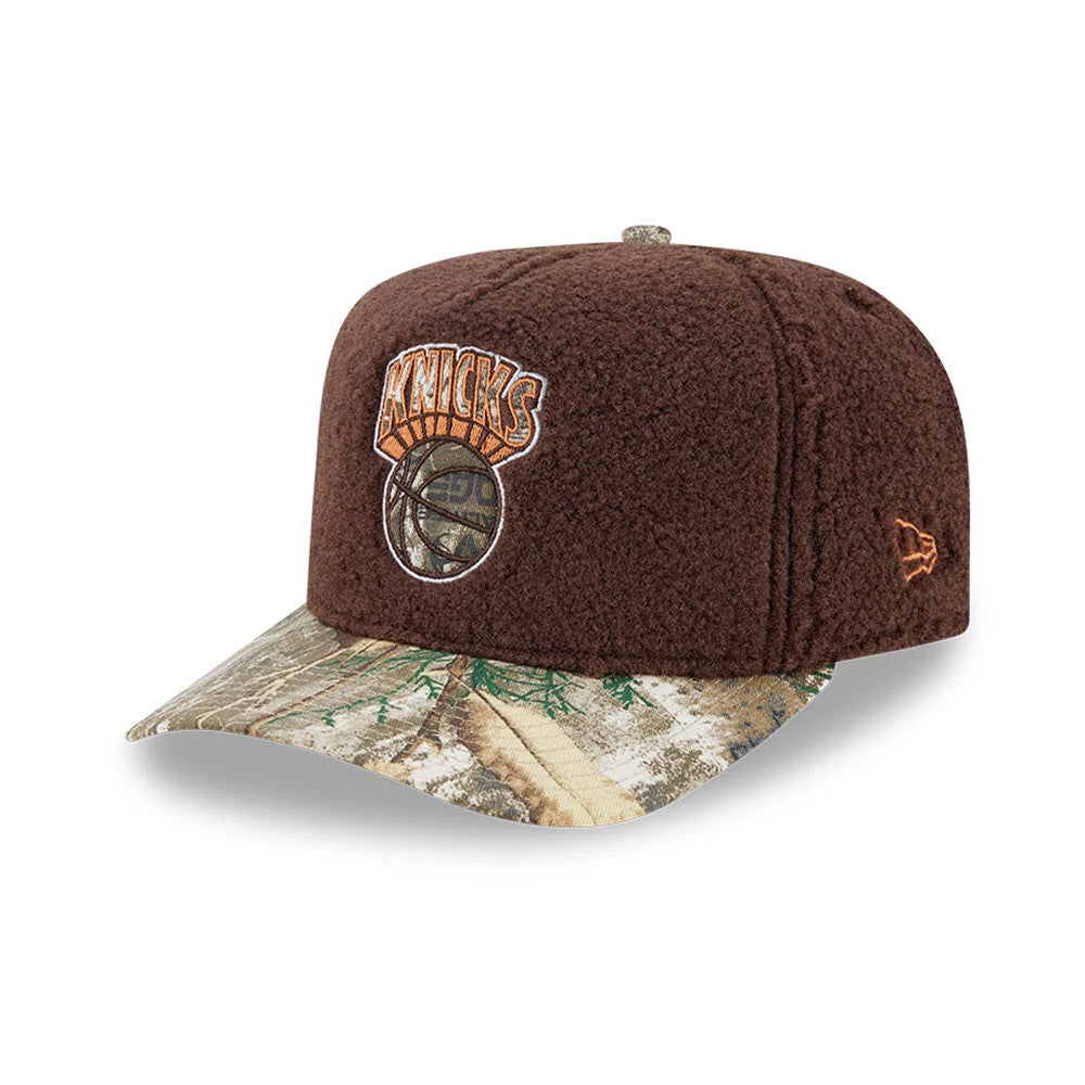 New York Knicks NBA Hardwood Classic Brown New Era 59FIFTY A-Frame Fitted Cap, three-quarter view showing an orange and brown embroidered Knicks logo on the front panel, a camouflage-patterned curved visor.