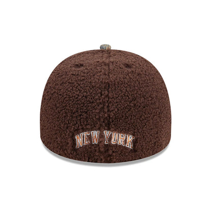 New York Knicks NBA Hardwood Classic Brown New Era 59FIFTY A-Frame Fitted Cap, rear view showing New York embroidered in white and orange on the plush brown textured fabric, with a patterned top button and no New Era flag logo.