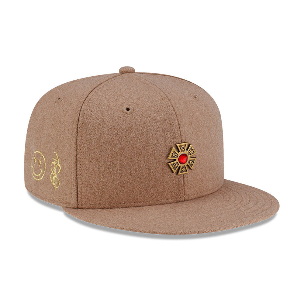 Pictured is this New Era X J Balvin & Ryan Castro Omerta New Era 59FIFTY Fitted cap in beige. 1