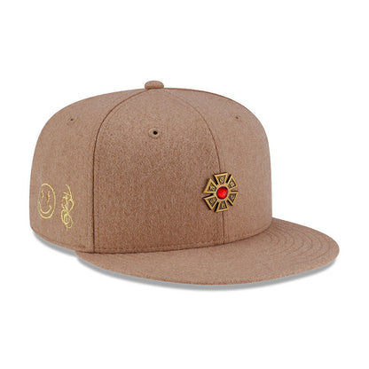 Pictured is this New Era X J Balvin & Ryan Castro Omerta New Era 59FIFTY Fitted cap in beige. 1