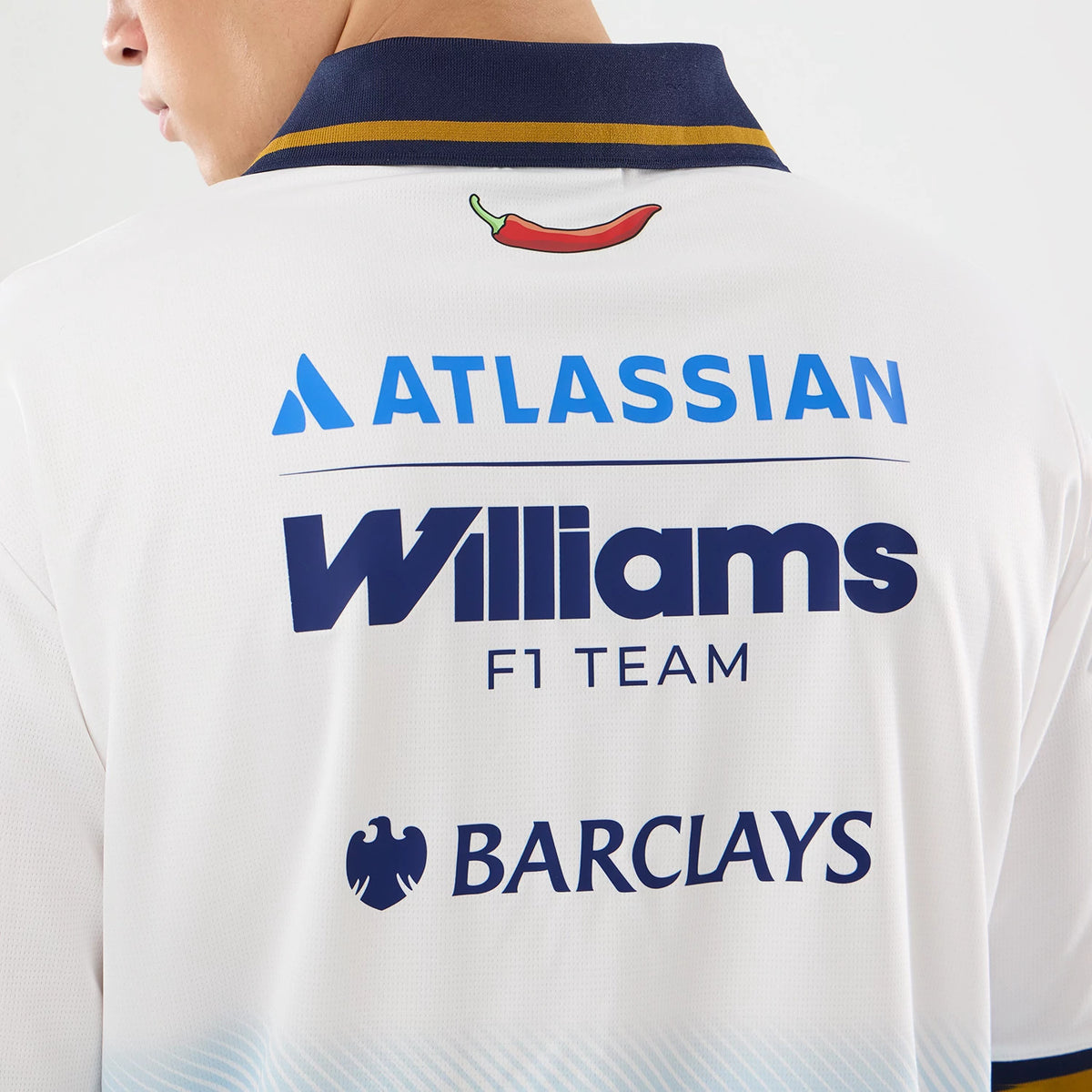New Era Williams Spain Race Special White T-Shirt, back view on a model showing a navy collar with a gold stripe, a chilli graphic below the collar, and blue printed logos for Atlassian, Williams F1 Team, and Barclays across the upper back.