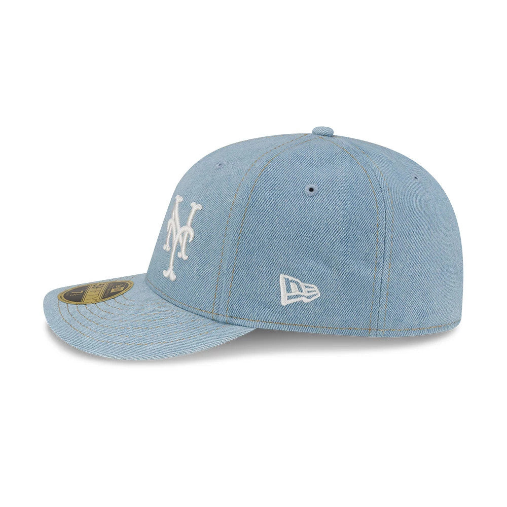 New York Mets MLB Denim Pastel Blue New Era Low Profile 59FIFTY Fitted Cap, three-quarter view showing the white embroidered Mets logo on the front panel, New Era flag logo on the left side, and gold 59FIFTY size sticker on the curved visor.