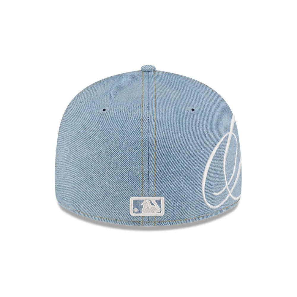 New York Mets MLB Denim Pastel Blue New Era Low Profile 59FIFTY Fitted Cap, rear view showing the white embroidered MLB Batterman logo at the centre of the back panels, with white stitching and white side logo on the structured denim crown.