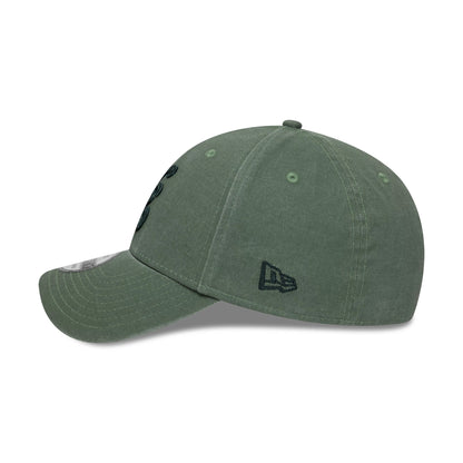 New Era Ombre Dark Green New Era 39THIRTY Stretch Fit Cap, side view showing the black embroidered New Era flag logo on the left side, a curved visor with stitching, and matching green eyelets and top button on the soft crown.