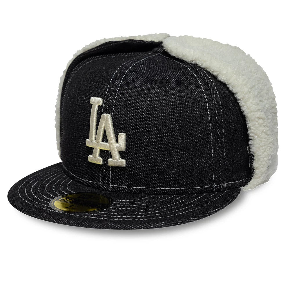 LA Dodgers MLB Denim Black New Era Dogear 59FIFTY Fitted Cap, three-quarter view showing the white embroidered LA logo on the front panel, black denim fabric with white stitching, and cream sherpa fleece ear flaps for warmth.