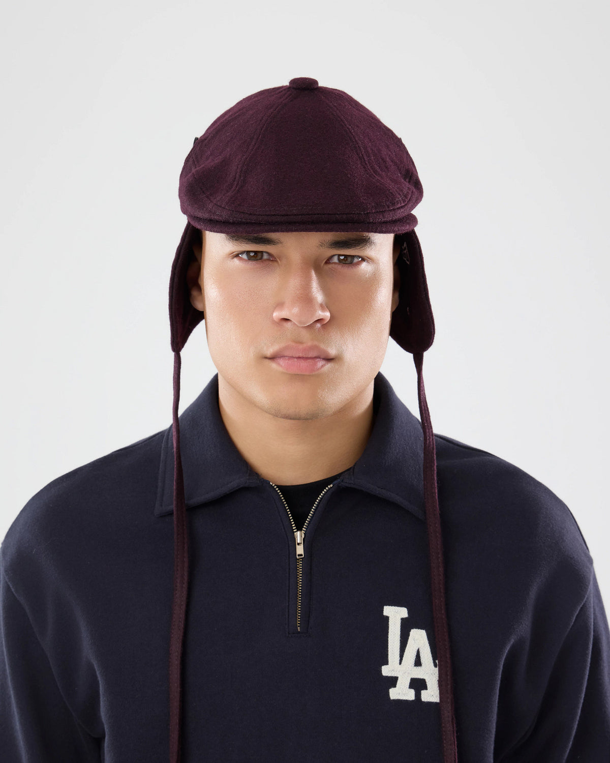 Pictured is this New Era Wool Downflap Driver cap in dark brown. 4
