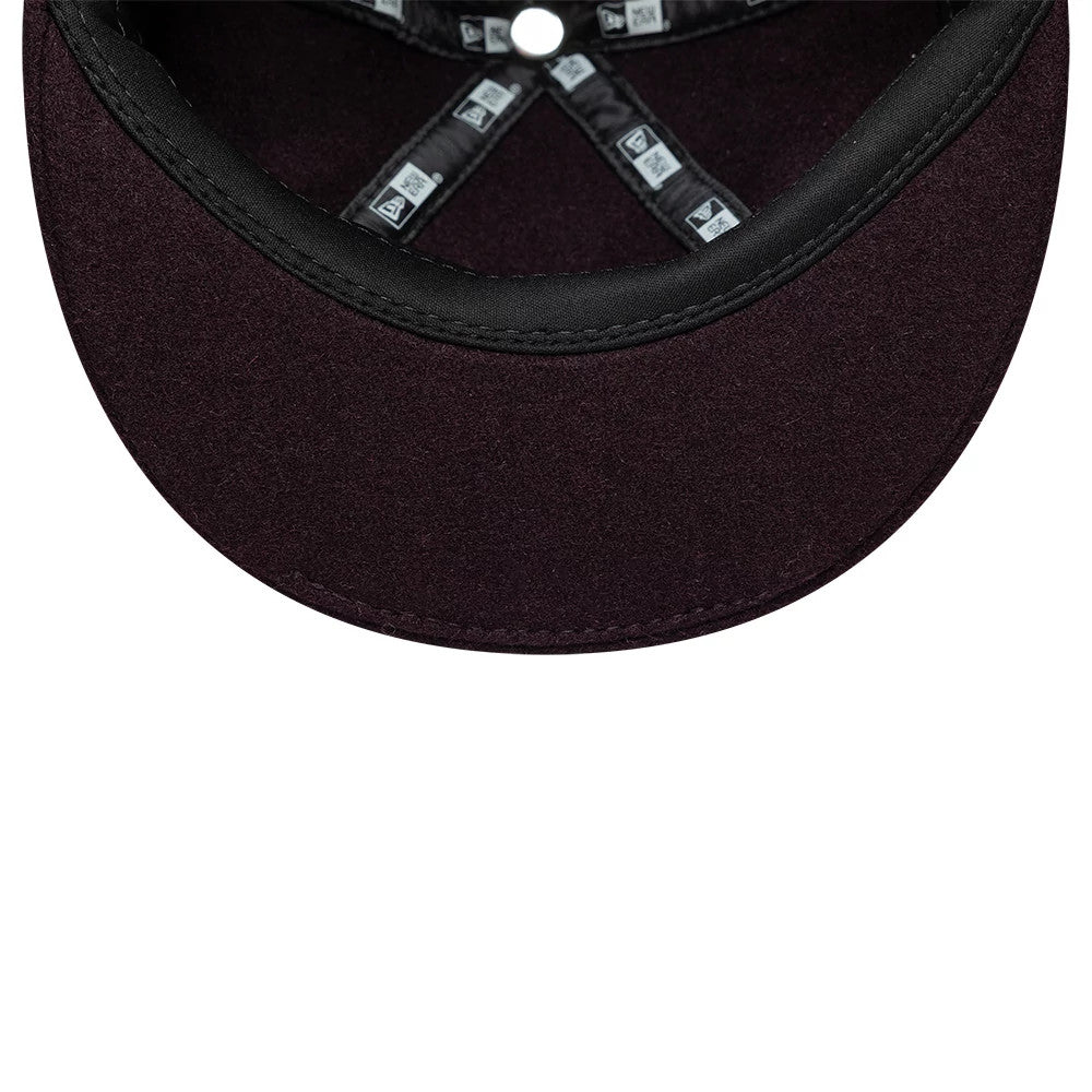 Pictured is this New Era Wool Downflap Driver cap in dark brown. 9