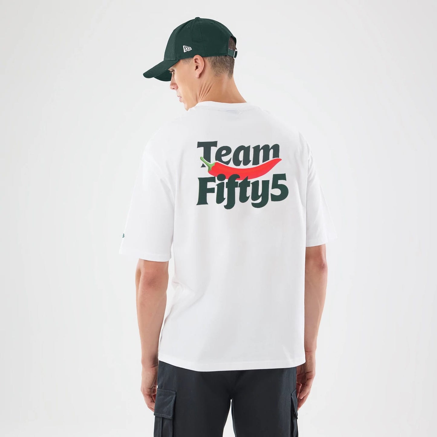 The model is wearing this Carlos Sainz Team Fifty5 Oversized T-Shirt in white. 2