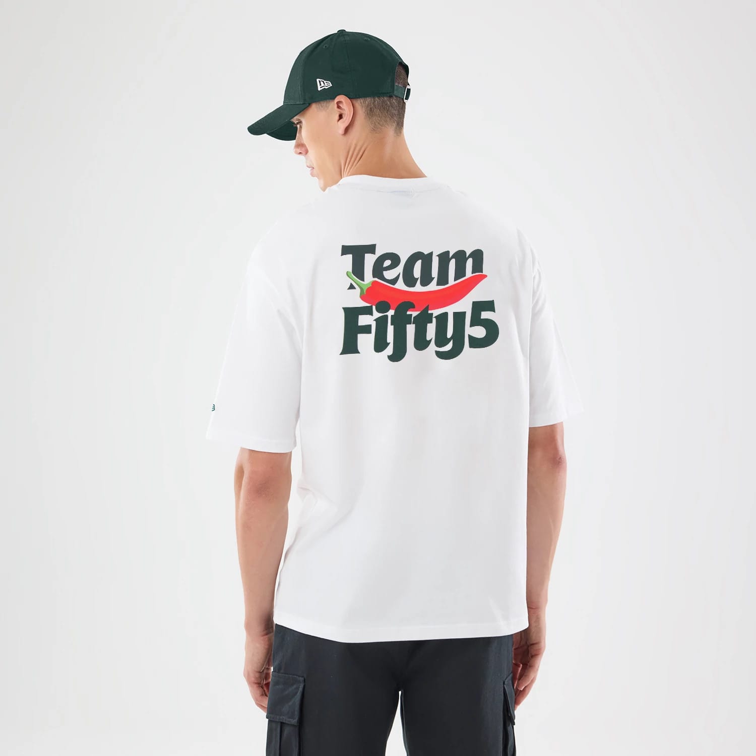 The model is wearing this Carlos Sainz Team Fifty5 Oversized T-Shirt in white. 2