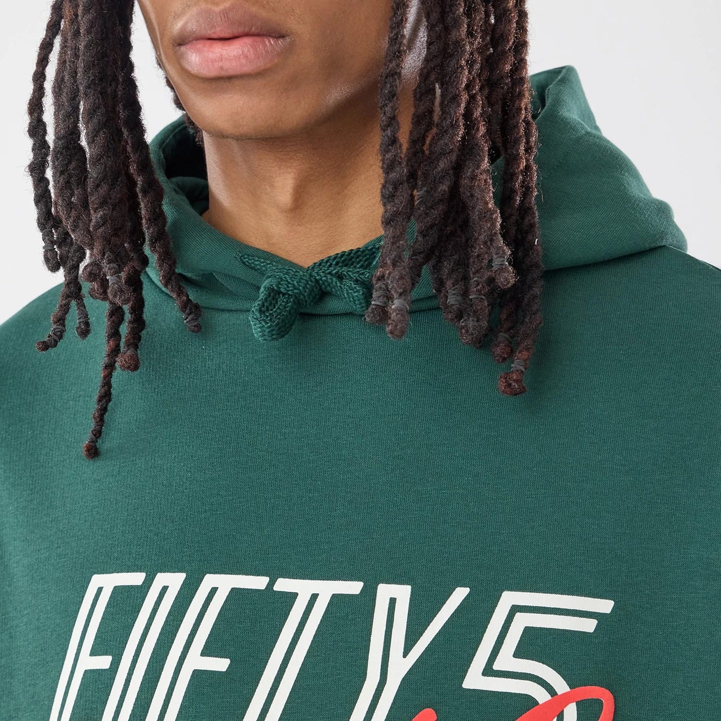 The model is wearing this Carlos Sainz Team Fifty5 Smooth Oversized Pullover Hoodie in dark green. 3