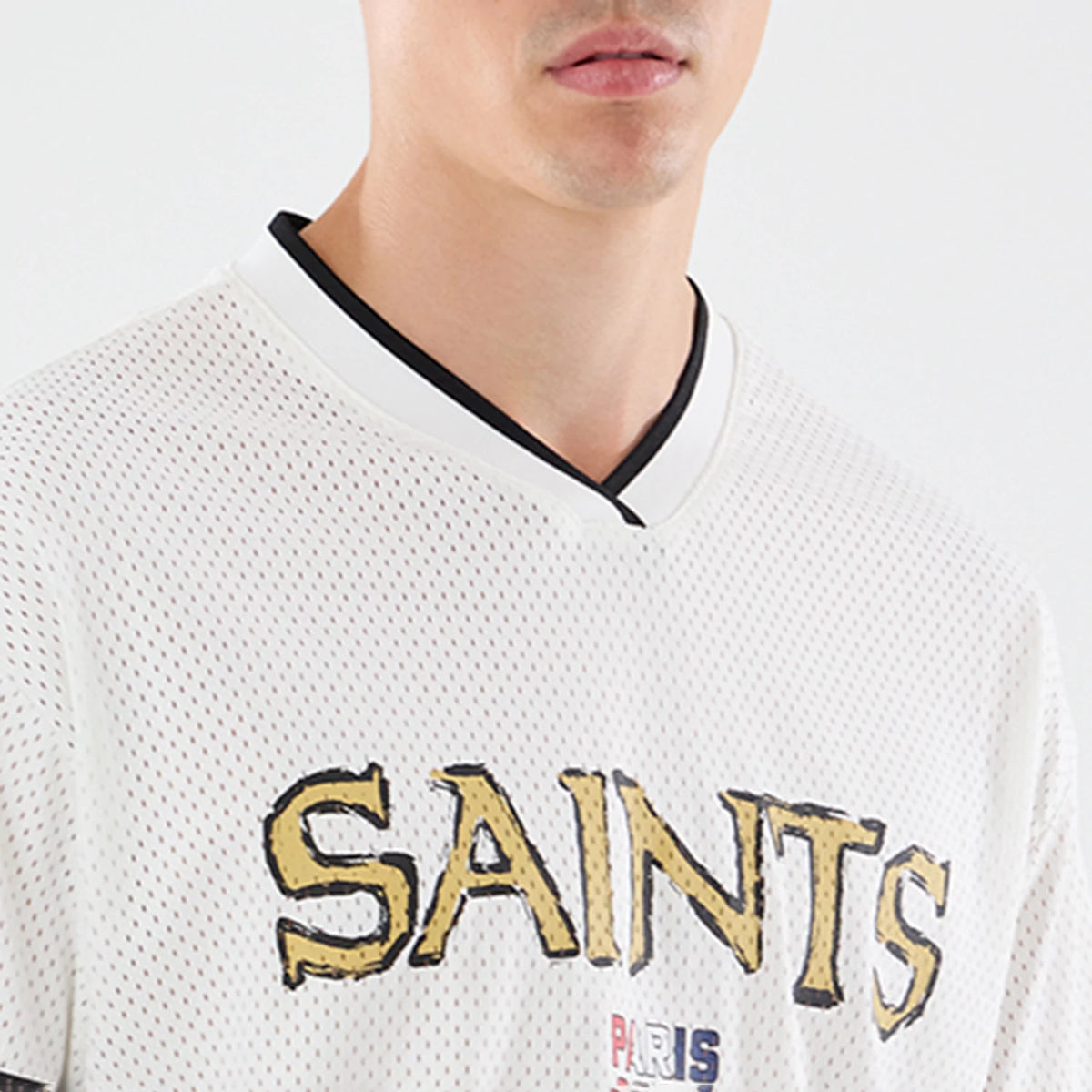 The model is wearing this NFL International Series Games 2026 Graphic New Orleans Saints Mesh Jersey in white. 3