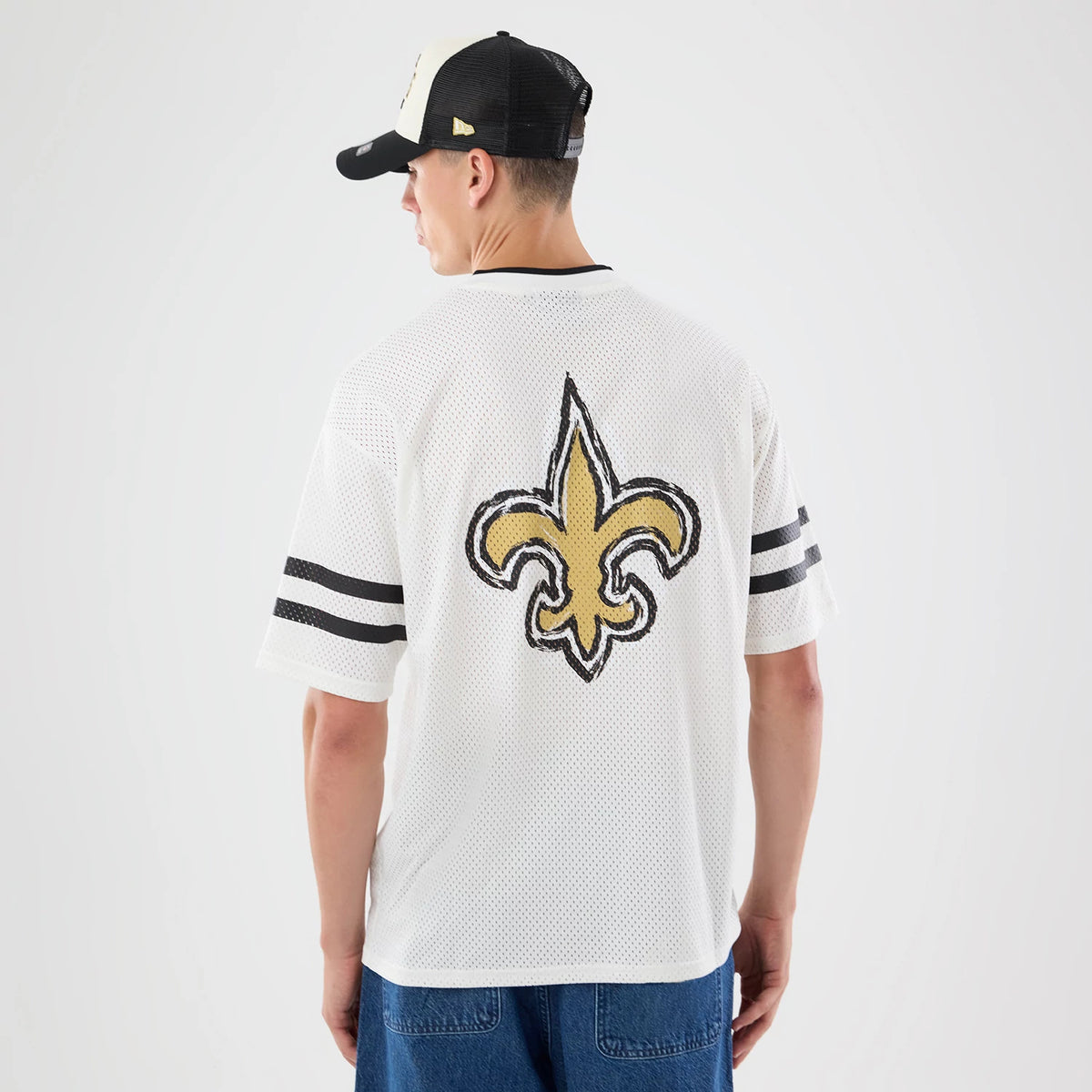 The model is wearing this NFL International Series Games 2026 Graphic New Orleans Saints Mesh Jersey in white. 2