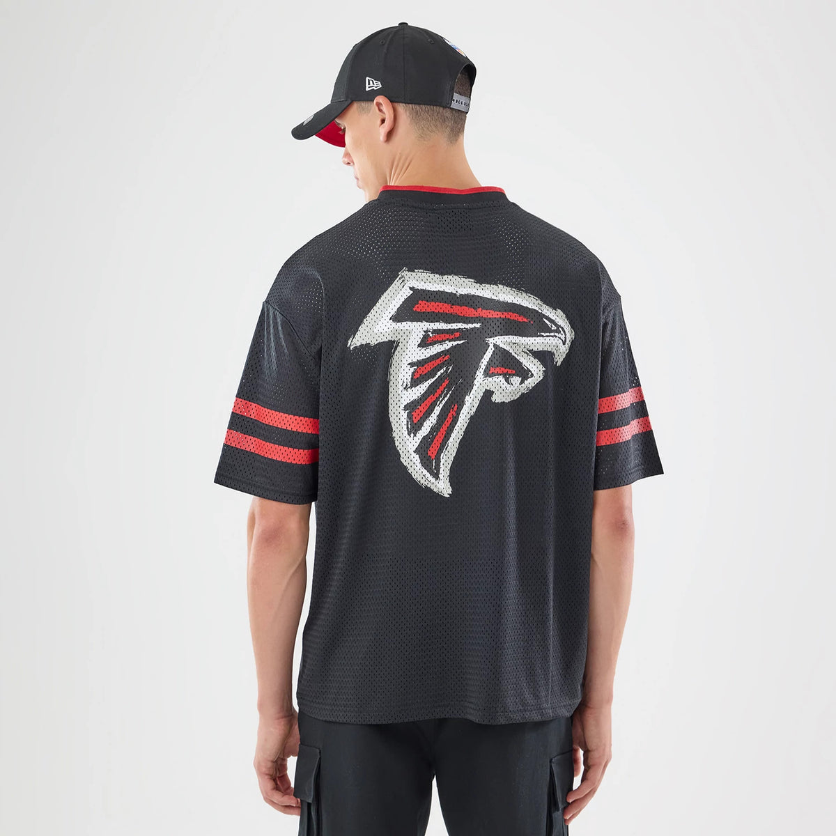 The model is wearing this NFL International Series Games 2026 Graphic Atlanta Falcons Mesh Jersey in black. 2
