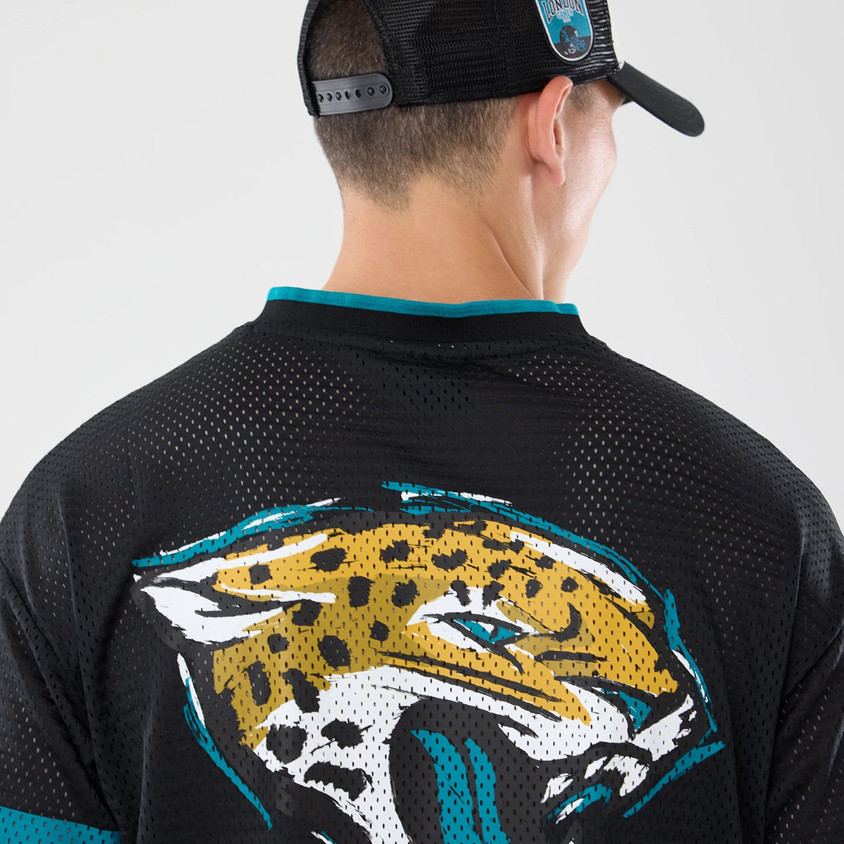 The model is wearing this NFL International Series Games 2026 Graphic Jacksonville Jaguars Mesh Jersey in black. 7