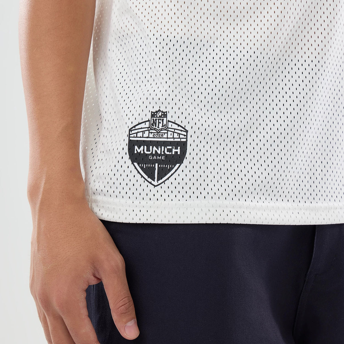 The model is wearing this NFL International Series Games 2026 Graphic Detroit Lions Mesh Jersey in white. 4