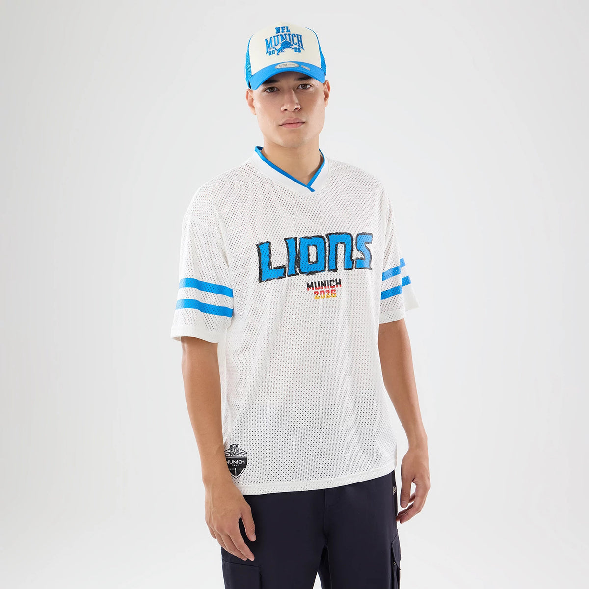 The model is wearing this NFL International Series Games 2026 Graphic Detroit Lions Mesh Jersey in white. 1