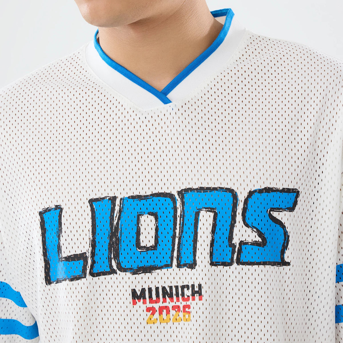 The model is wearing this NFL International Series Games 2026 Graphic Detroit Lions Mesh Jersey in white. 6