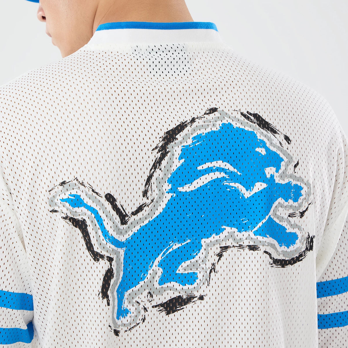 The model is wearing this NFL International Series Games 2026 Graphic Detroit Lions Mesh Jersey in white. 7