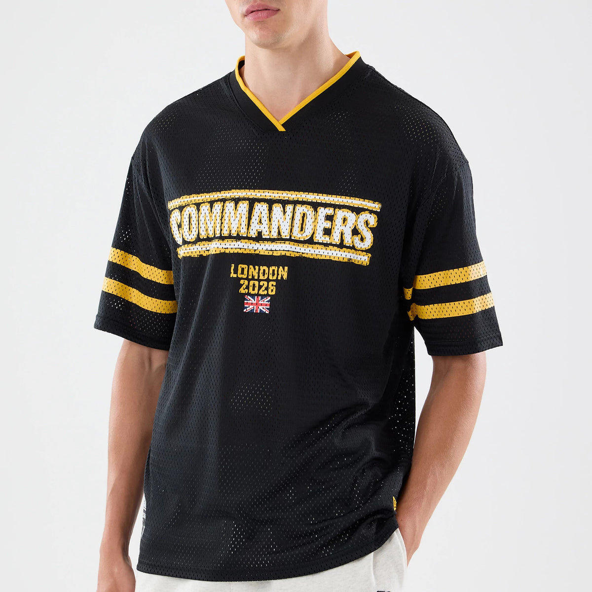 The model is wearing this NFL International Series Games 2026 Graphic Washington Commanders Mesh Jersey in black. 3