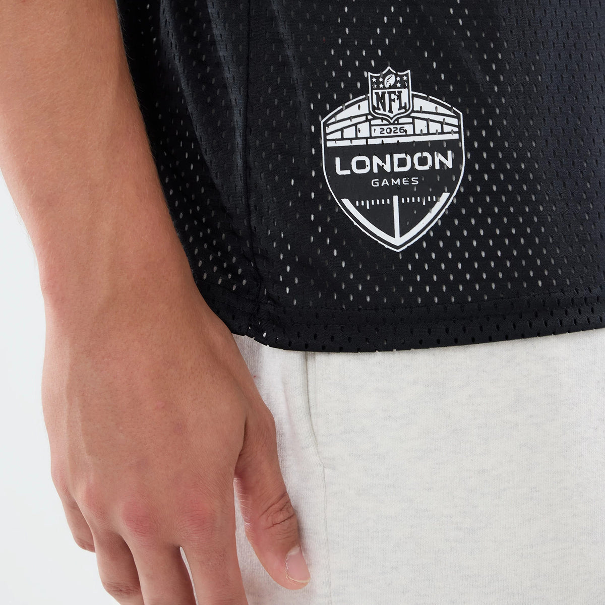 The model is wearing this NFL International Series Games 2026 Graphic Washington Commanders Mesh Jersey in black. 5