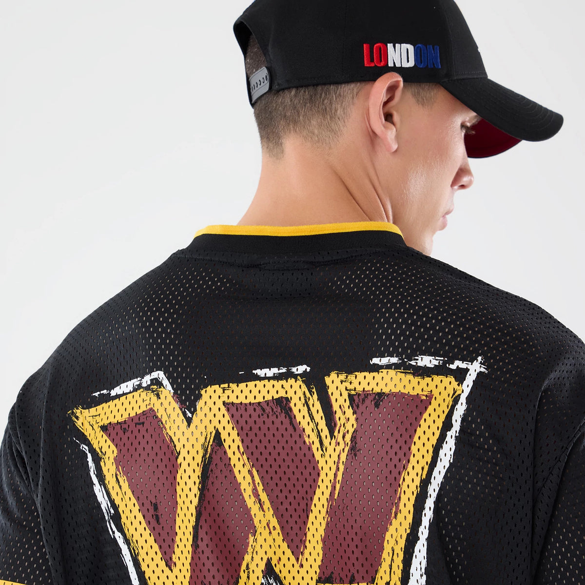 The model is wearing this NFL International Series Games 2026 Graphic Washington Commanders Mesh Jersey in black. 4