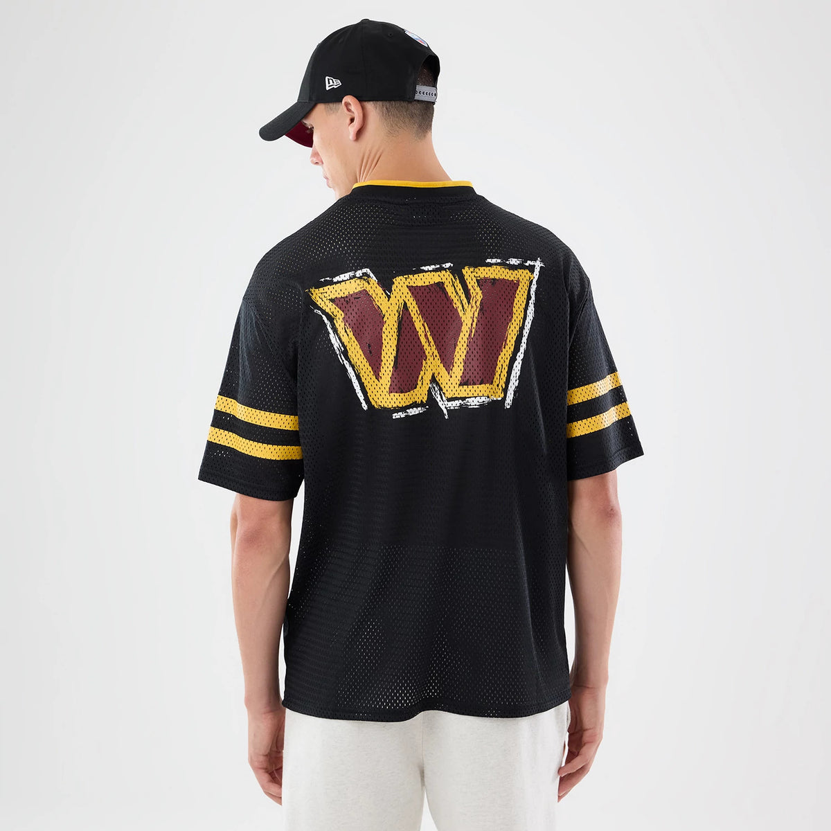 The model is wearing this NFL International Games 2026 Graphic Washington Commanders Mesh Jersey in black. 2