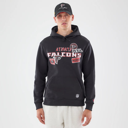 New Era Atlanta Falcons NFL Patch Black Pullover Hoodie, front view on a model styled with a cap, displaying multiple embroidered team patches on the chest, a central kangaroo pocket, and a small NFL logo near the hem.