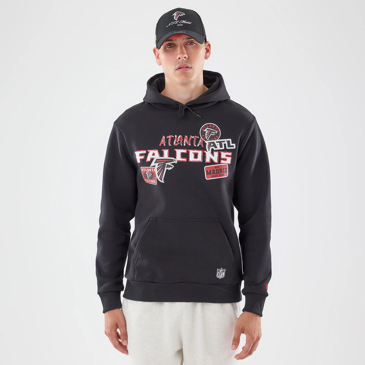 The model is wearing this NFL Patch Atlanta Falcons Pullover Hoodie in black. 1