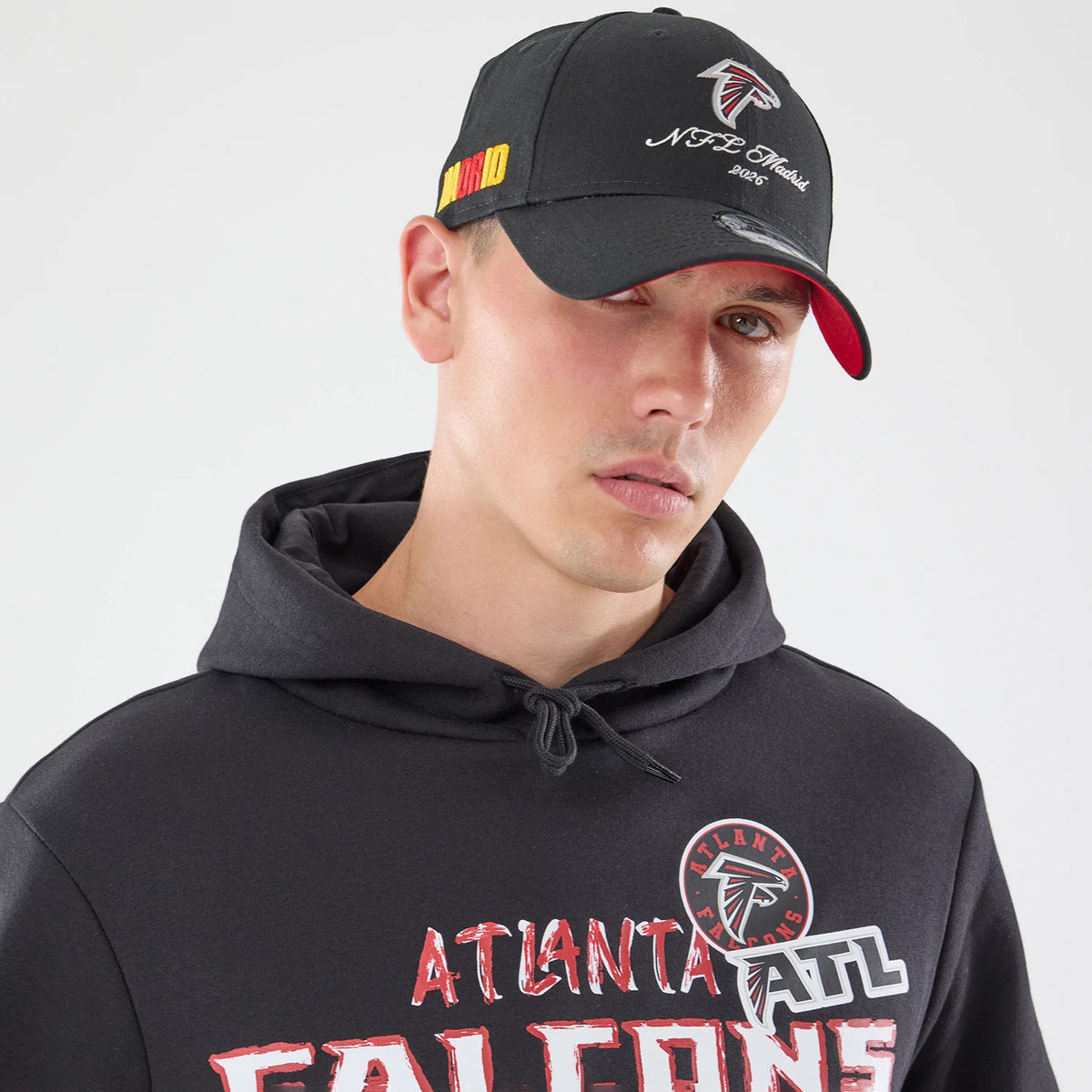 The model is wearing this NFL Patch Atlanta Falcons Pullover Hoodie in black. 6