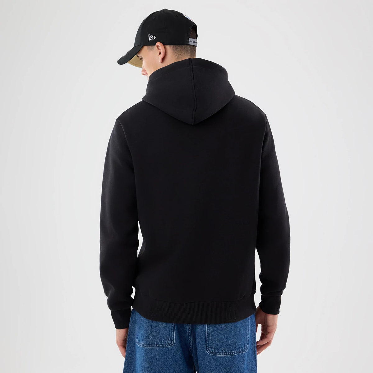 The model is wearing this NFL Patch New Orleans Saints Pullover Hoodie in black. 2