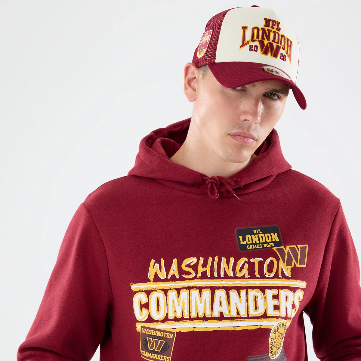 The model is wearing this NFL Patch Washington Commanders Pullover Hoodie in dark red. 5