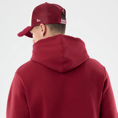 The model is wearing this NFL Patch Washington Commanders Pullover Hoodie in dark red. 3