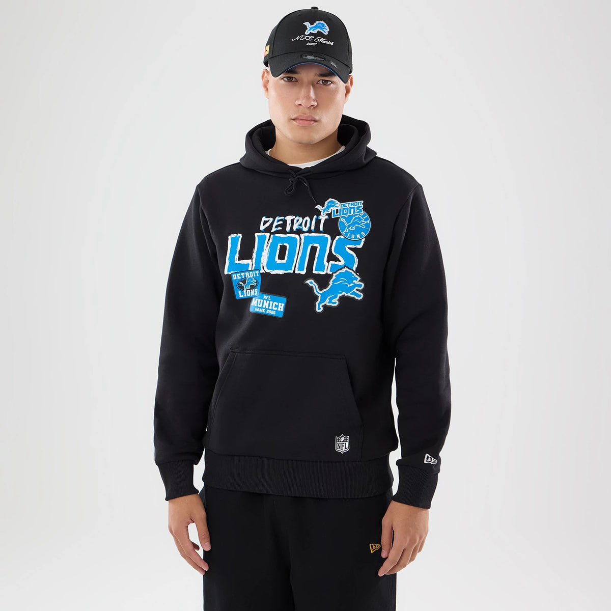 The model is wearing this NFL Patch Detroit Lions Pullover Hoodie in black. 1