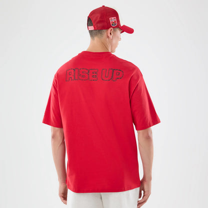 The model is wearing this NFL Graphic Slogan Atlanta Falcons Oversized T-Shirt in red. 2
