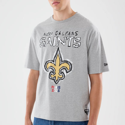 New Era New Orleans Saints NFL Graphic Slogan Grey Oversized T-Shirt, front view on a model featuring the New Orleans Saints logo prominently in yellow with black outlining, text reading New Orleans Saints above it.