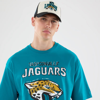 New Era Jacksonville Jaguars NFL Graphic Slogan Turquoise Oversized T-Shirt, front view on-model showing jaguar’s head graphic and textured Jacksonville Jaguars lettering across the chest.