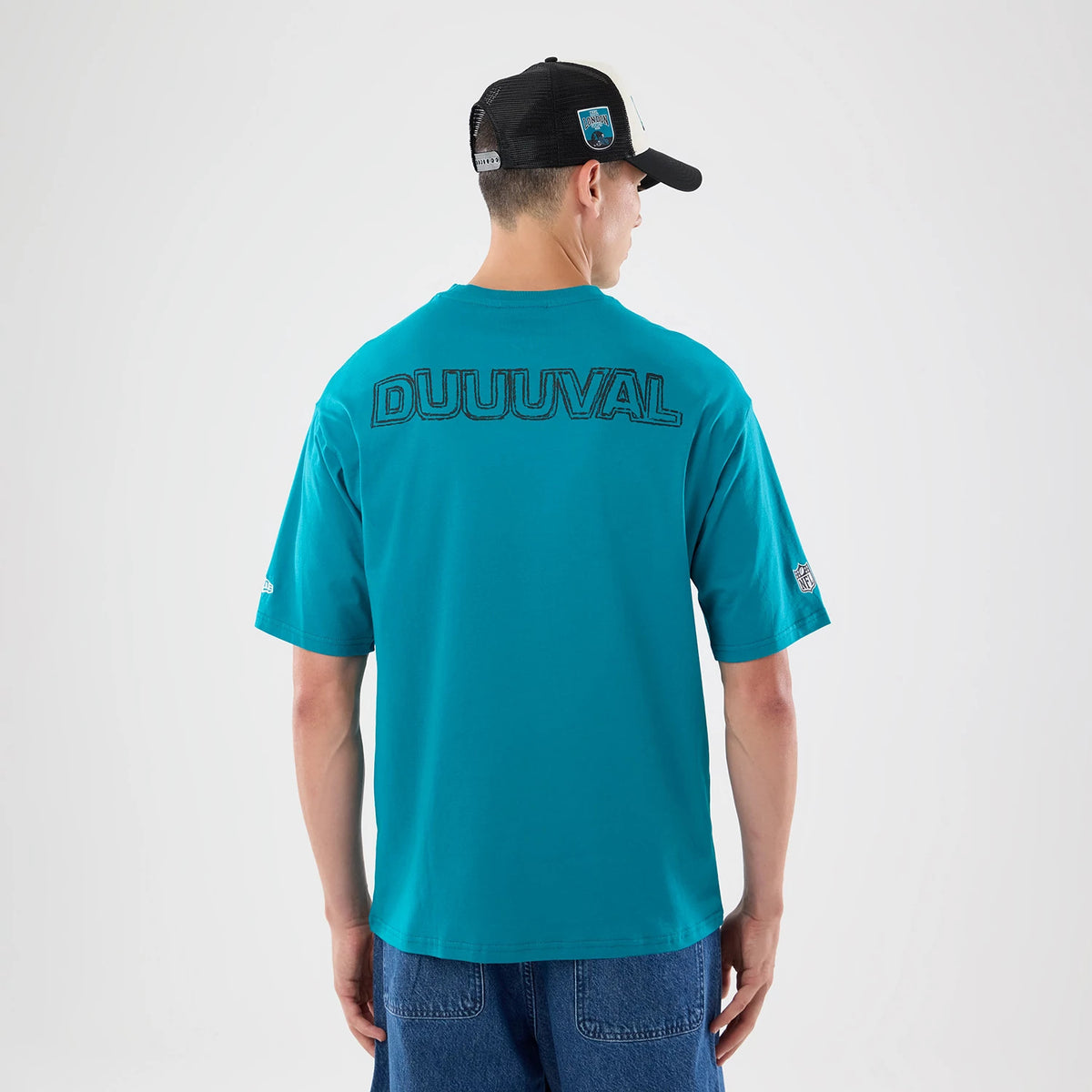 The model is wearing this NFL Graphic Slogan Jacksonville Jaguars Oversized T-Shirt in turquoise. 2