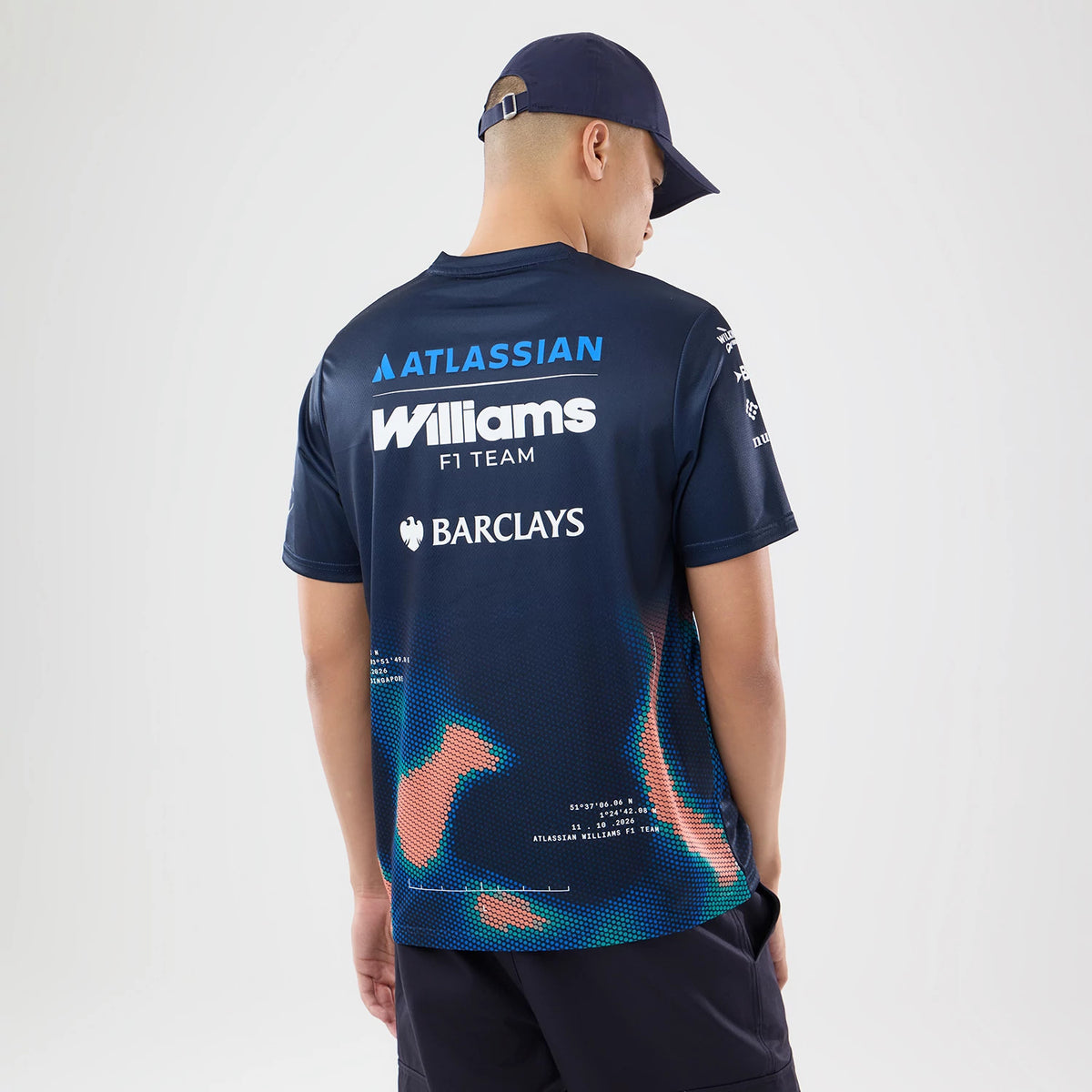 New Era Williams Singapore Navy Tech T-Shirt, back view on a model wearing a navy cap, featuring prominent white Williams F1 Team branding across the upper back, Atlassian and Barclays logos.