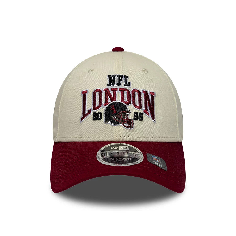 Commanders NFL International Games 2026 London White & Dark Red New Era 9FORTY M-Crown Adjustable Cap, front view showing raised black, red and white NFL London 2026 embroidery with a helmet graphic on the cream front panel.